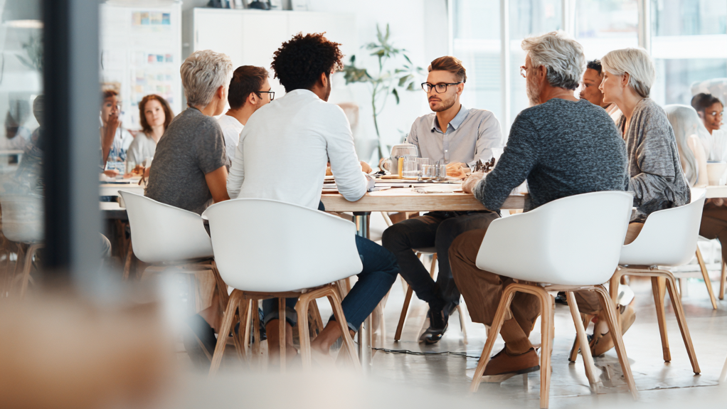 u7179724522_A_group_of_people_sitting_together_at_white_table_4a0d55e7-7e58-4925-80a6-251425363b0e_3
